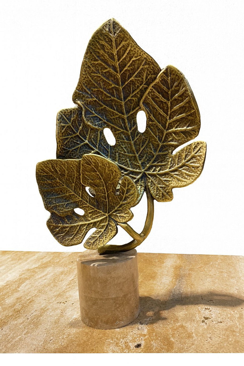 Brass Monstera Leaf Sculpture on Travertine