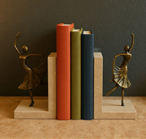 Brass Dancer Bookends on Travertine