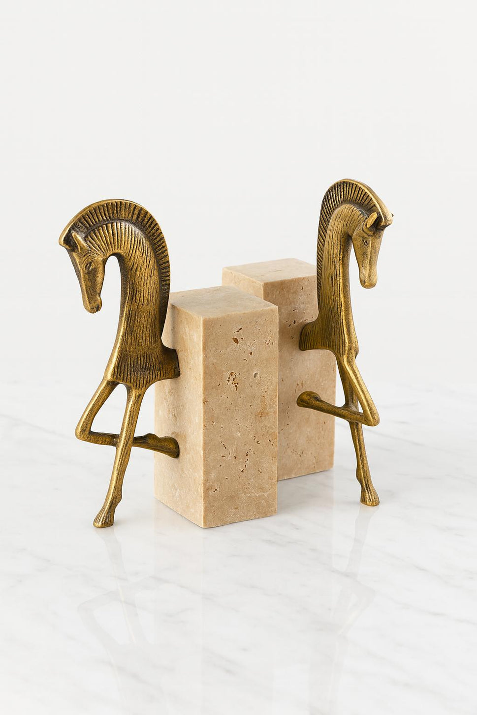 Brass Horse Bookends on Travertine
