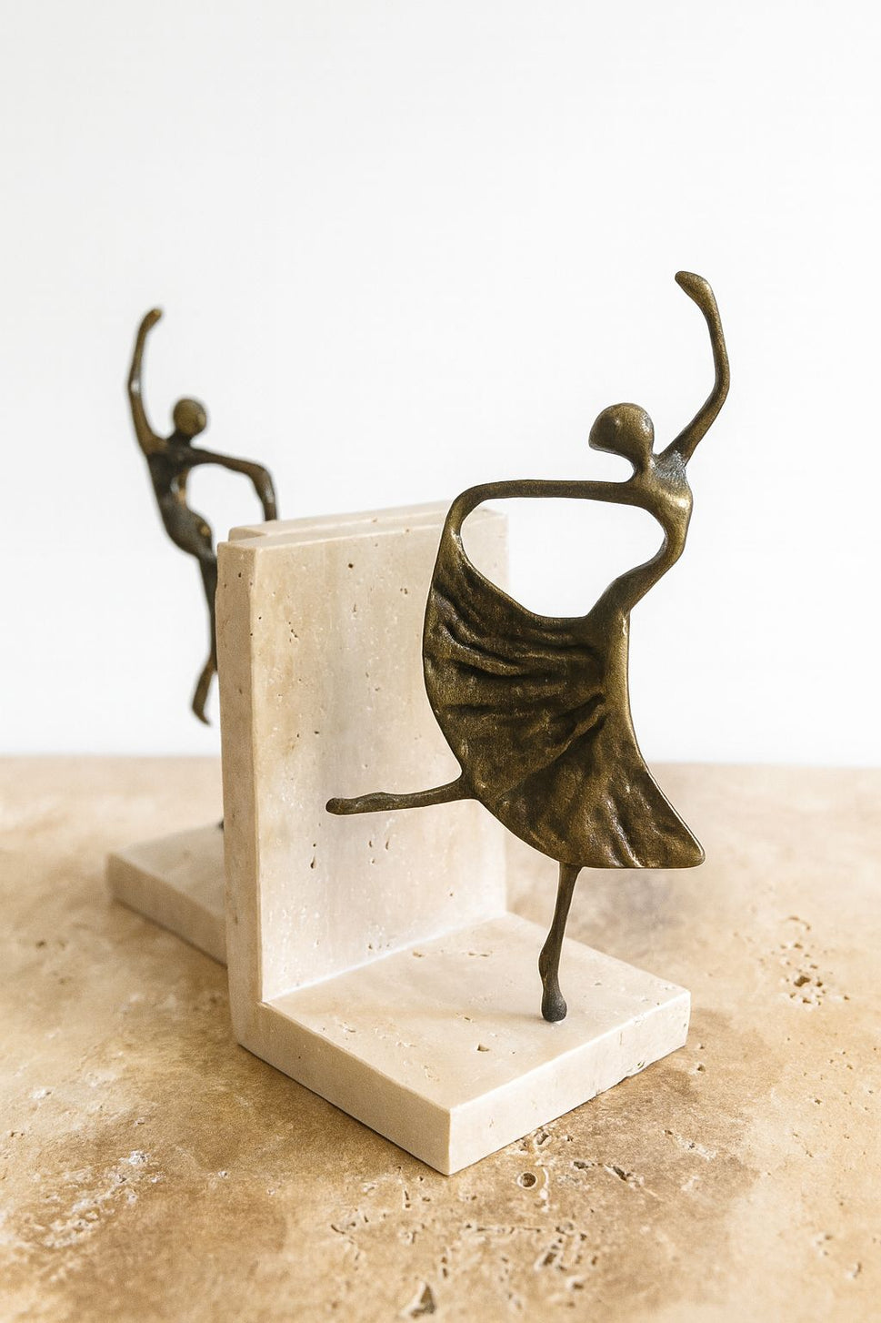 Brass Dancer Bookends on Travertine