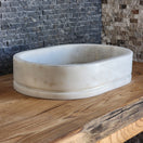 Switch White marble bowl on a wooden surface with a textured background 3 image