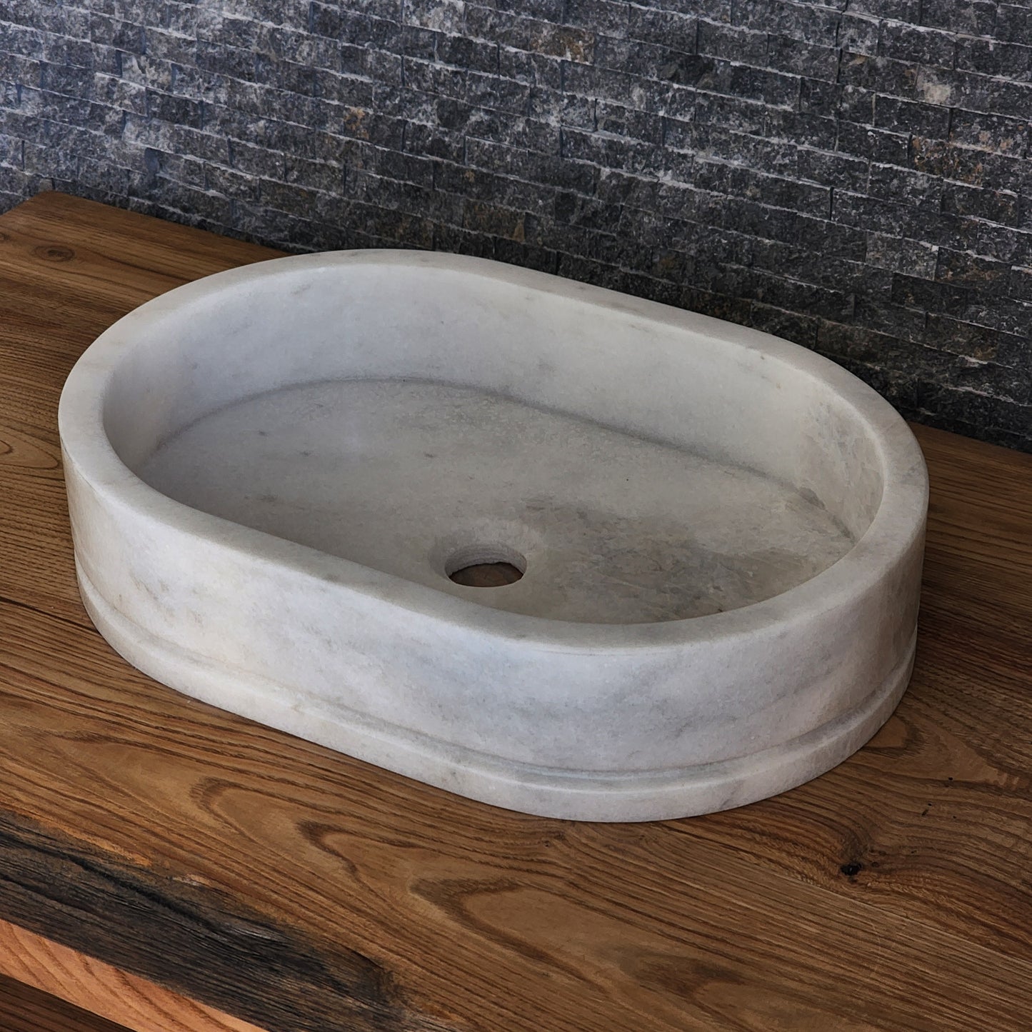 Marble sink on a wooden floor