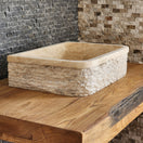 Switch Norhew luxury D-shaped solid travertine vessel sink with a hand-chiseled texture on both the curved front and flat back side. 3 image