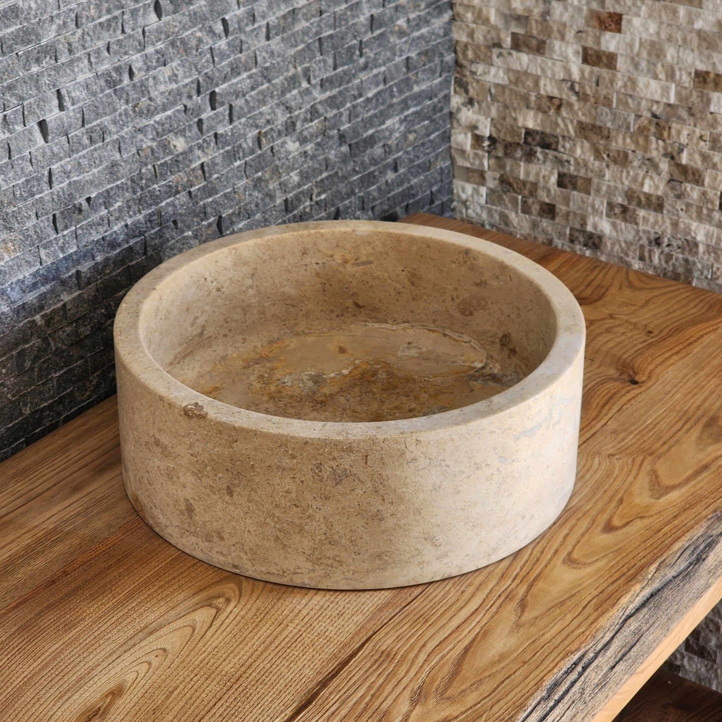Norhew luxury organic natural-shape travertine vessel sink with a weathered split-face exterior and a smooth honed interior.