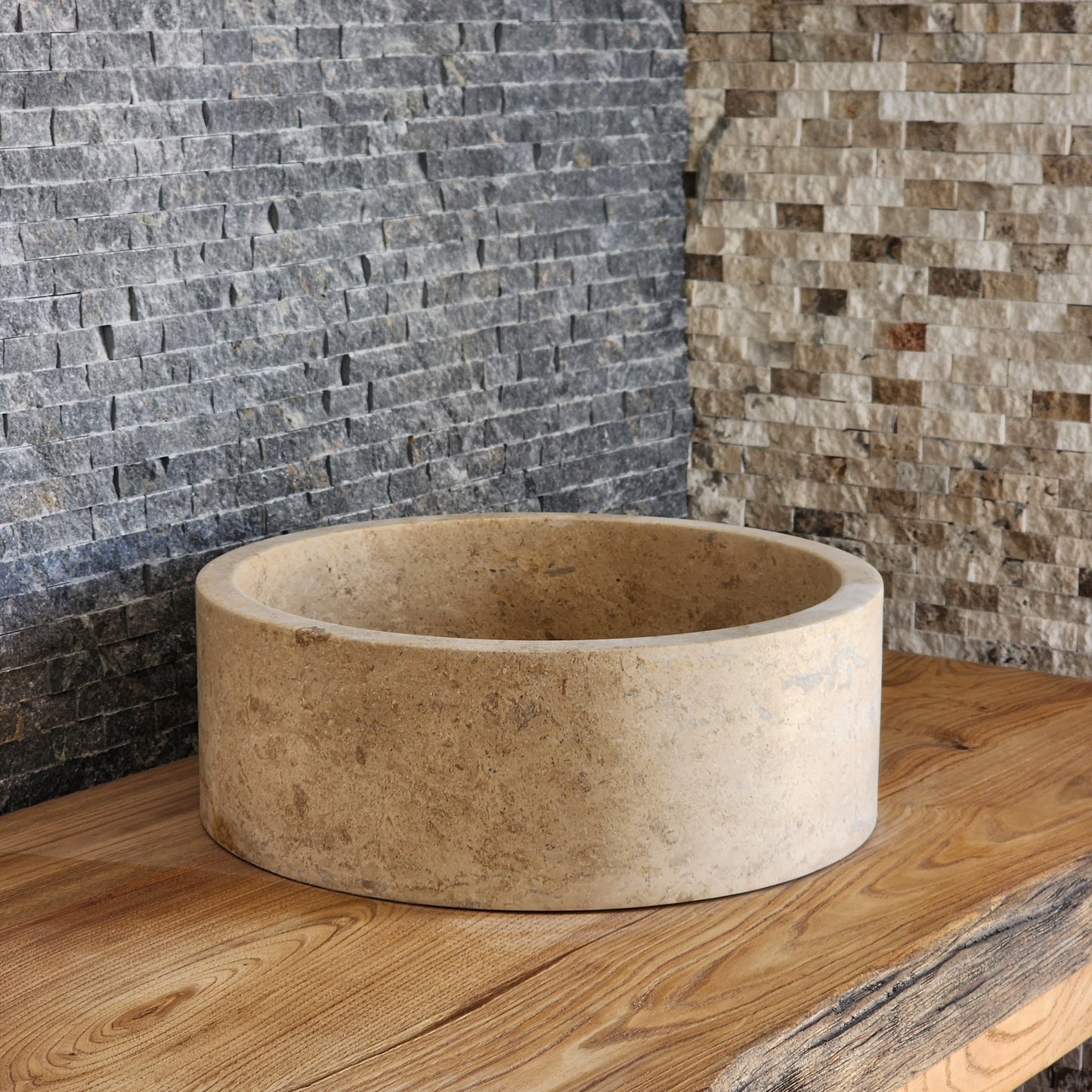 Norhew luxury organic natural-shape travertine vessel sink with a weathered split-face exterior and a smooth honed interior.