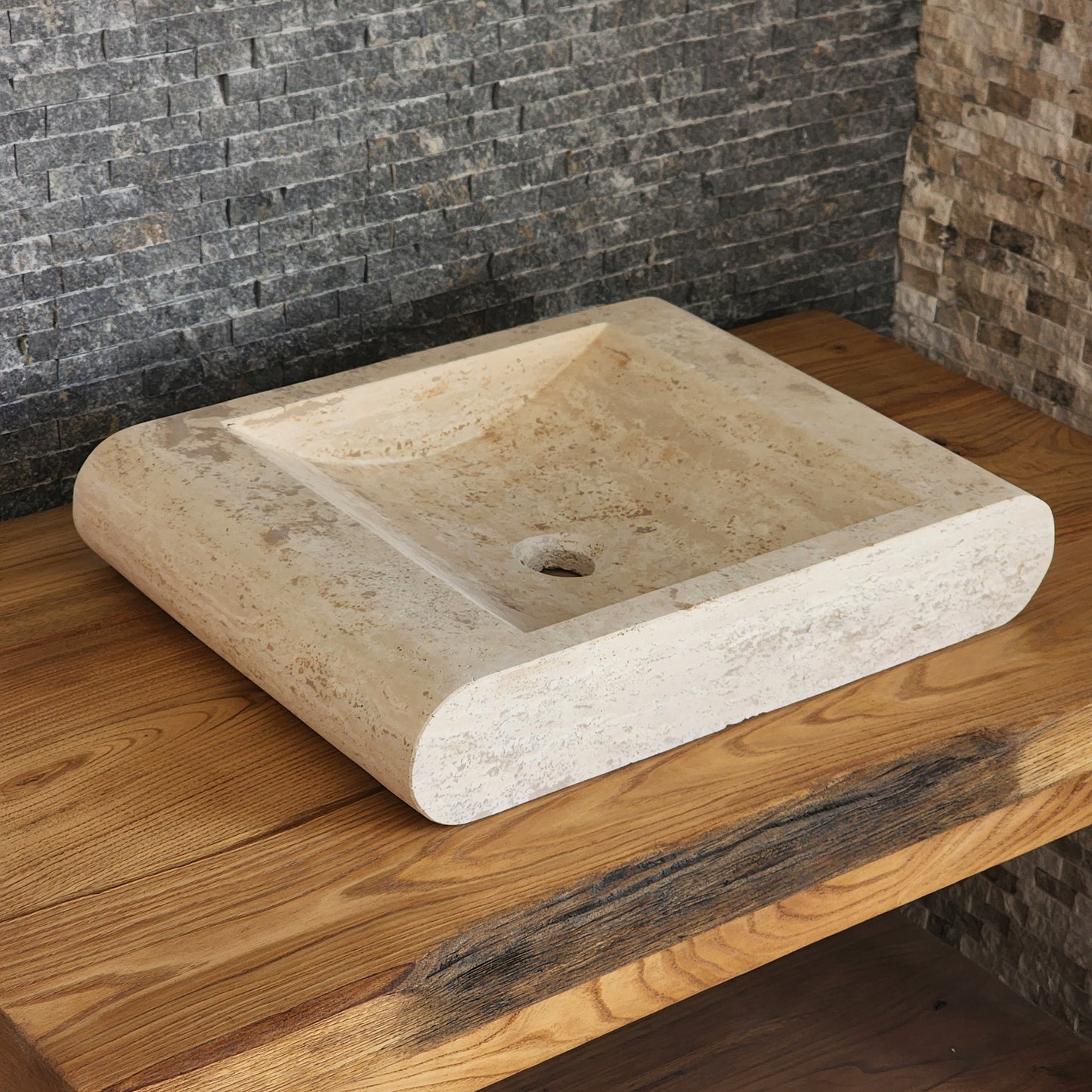 Norhew luxury rectangular travertine vessel sink with a sloped infinity interior and smooth radius-curved edges on a wooden vanity.