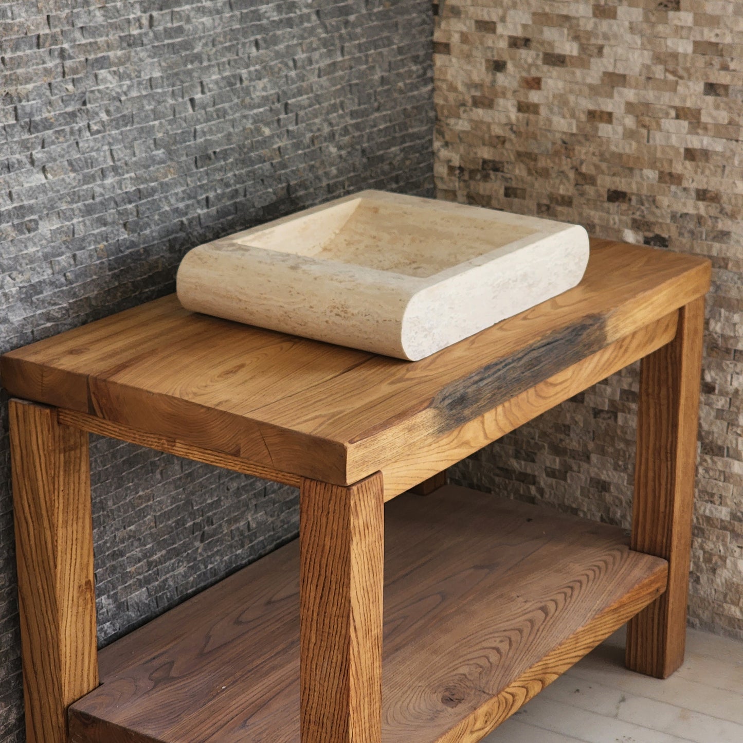 Norhew luxury rectangular travertine vessel sink with a sloped infinity interior and smooth radius-curved edges on a wooden vanity.