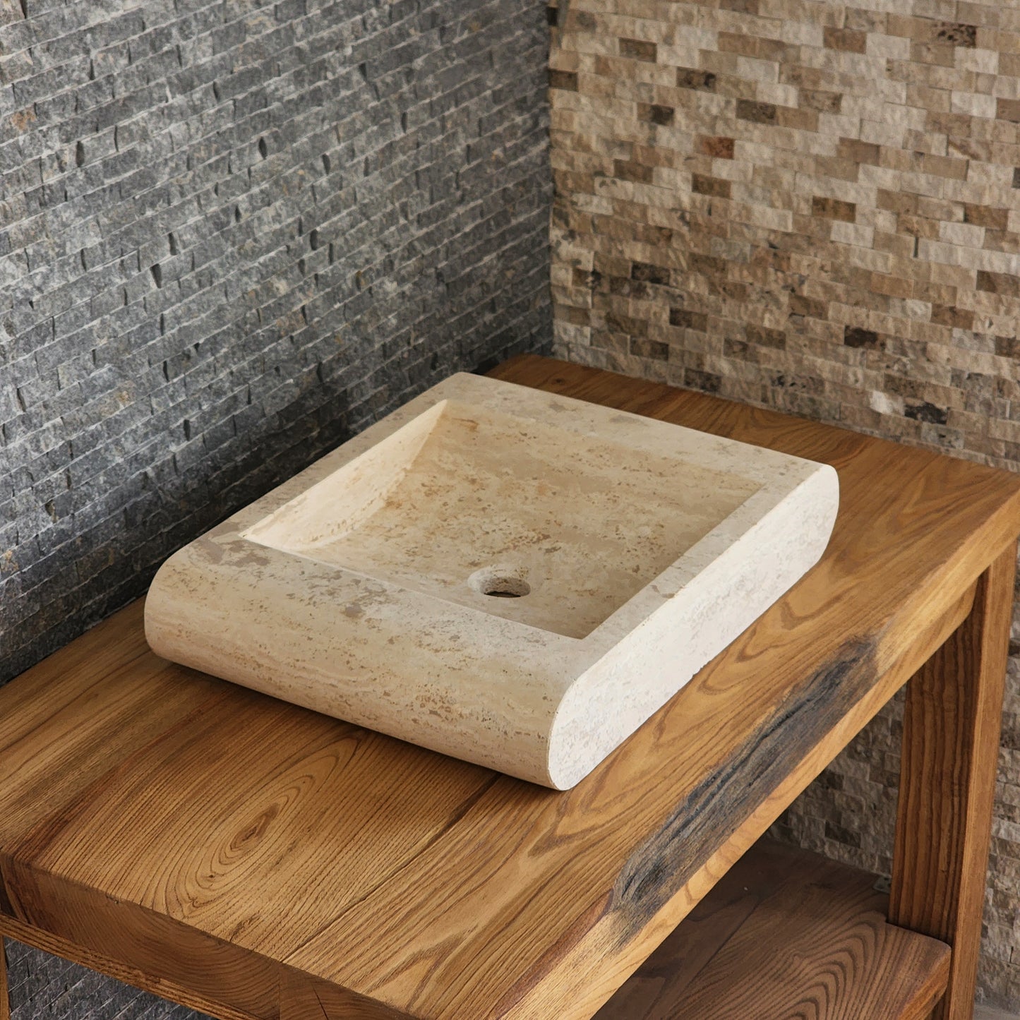 Norhew luxury rectangular travertine vessel sink with a sloped infinity interior and smooth radius-curved edges on a wooden vanity.