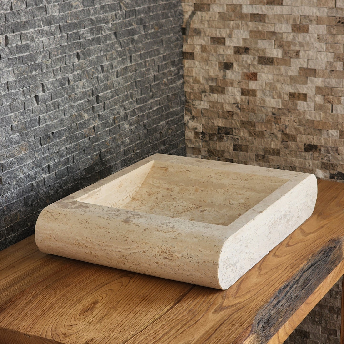 Norhew luxury rectangular travertine vessel sink with a sloped infinity interior and smooth radius-curved edges on a wooden vanity.