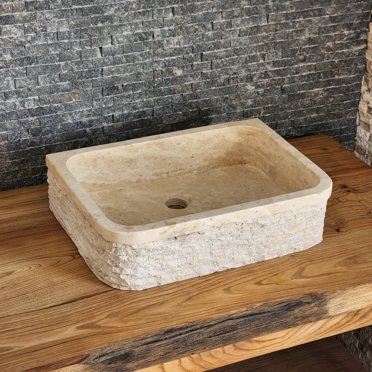 Norhew luxury D-shaped solid travertine vessel sink with a hand-chiseled texture on both the curved front and flat back side.