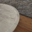 Switch luxury round white marble vessel sink with a thick architectural rim and natural grey veining on a warm wood vanity. 2 image