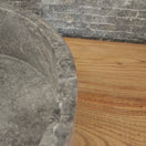 Switch Norhew luxury round gray storm marble vessel sink with dramatic charcoal and white crystalline veining on a rustic wood vanity. 2 image