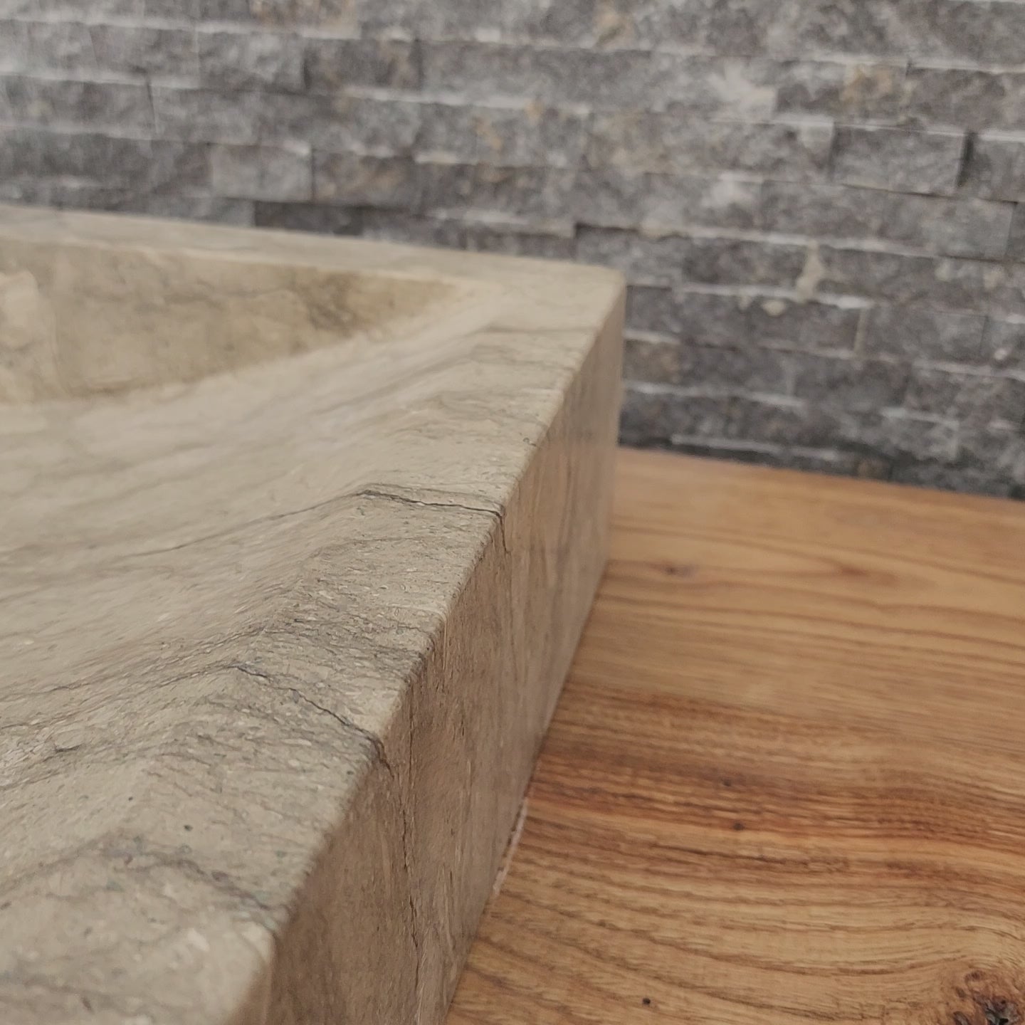 Norhew luxury rectangular marble vessel sink with extraordinary wavy olive and charcoal mineral veining on a light wood vanity.