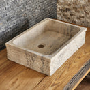 Switch Norhew luxury rectangular travertine vessel sink featuring a hand-chiseled raw stone exterior and a smooth honed interior on a solid wood vanity. 3 image