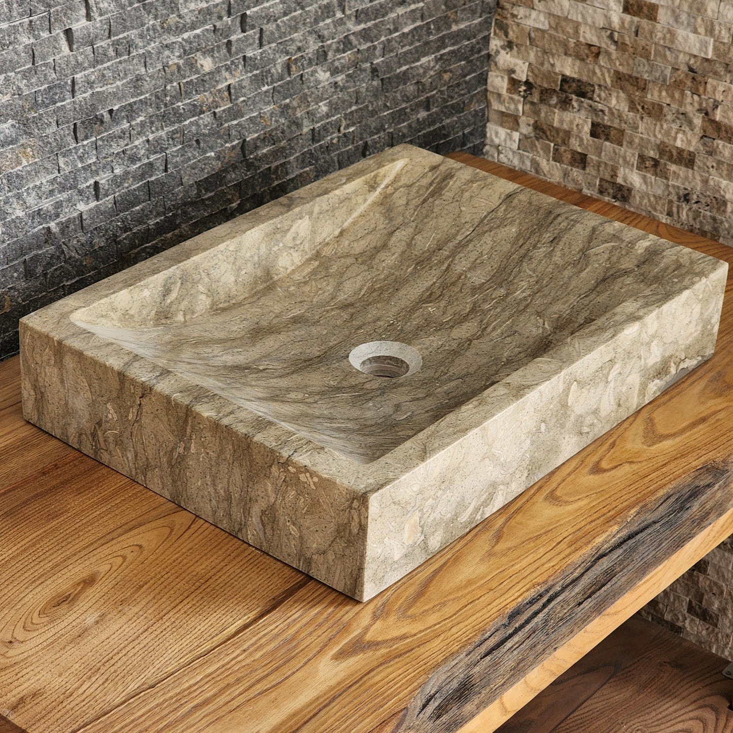 Norhew luxury rectangular marble vessel sink with extraordinary wavy olive and charcoal mineral veining on a light wood vanity.