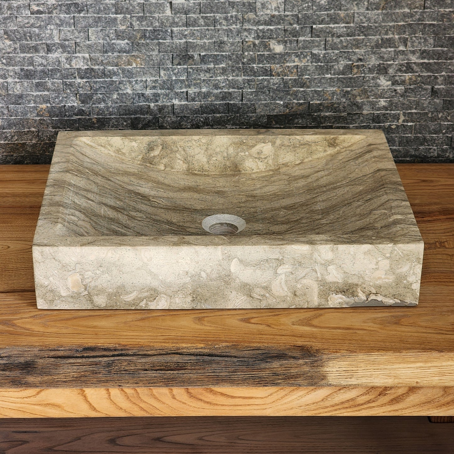 Norhew luxury rectangular marble vessel sink with extraordinary wavy olive and charcoal mineral veining on a light wood vanity.