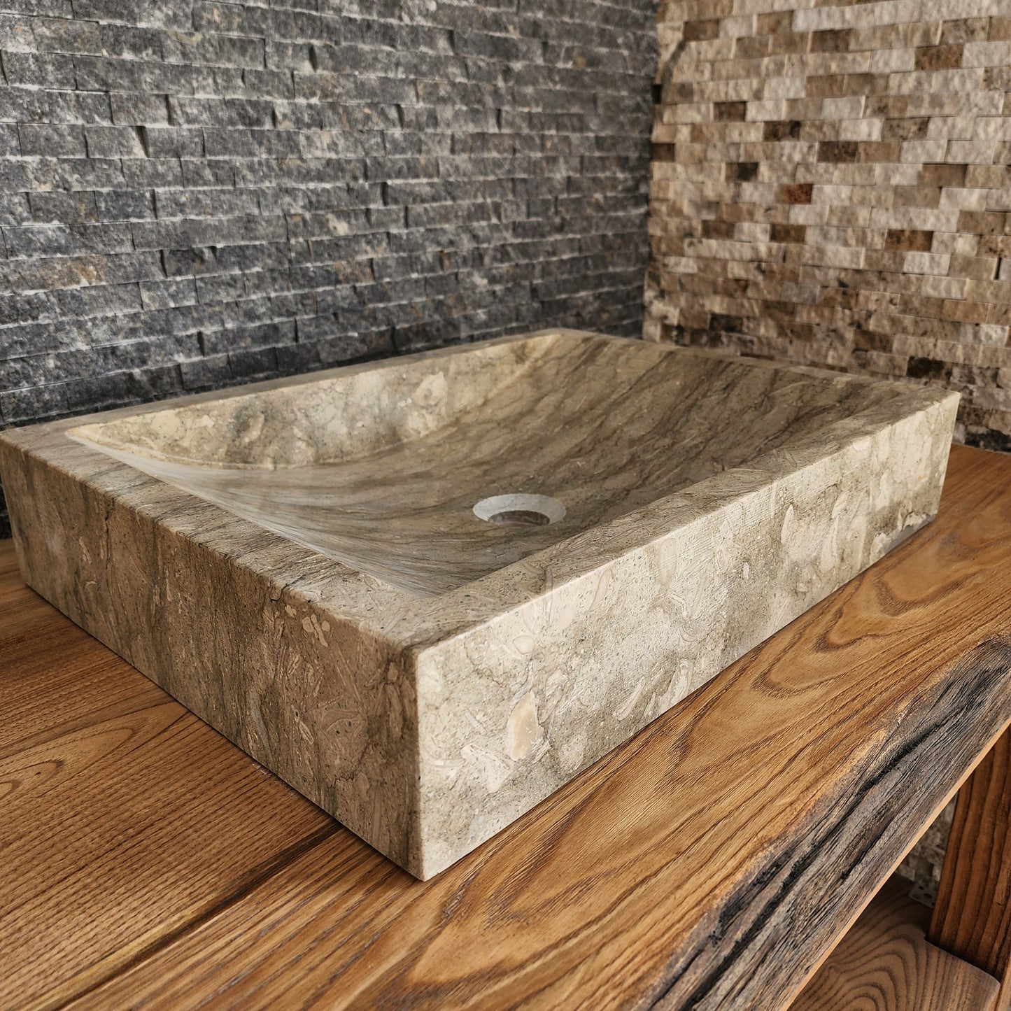 Norhew luxury rectangular marble vessel sink with extraordinary wavy olive and charcoal mineral veining on a light wood vanity.