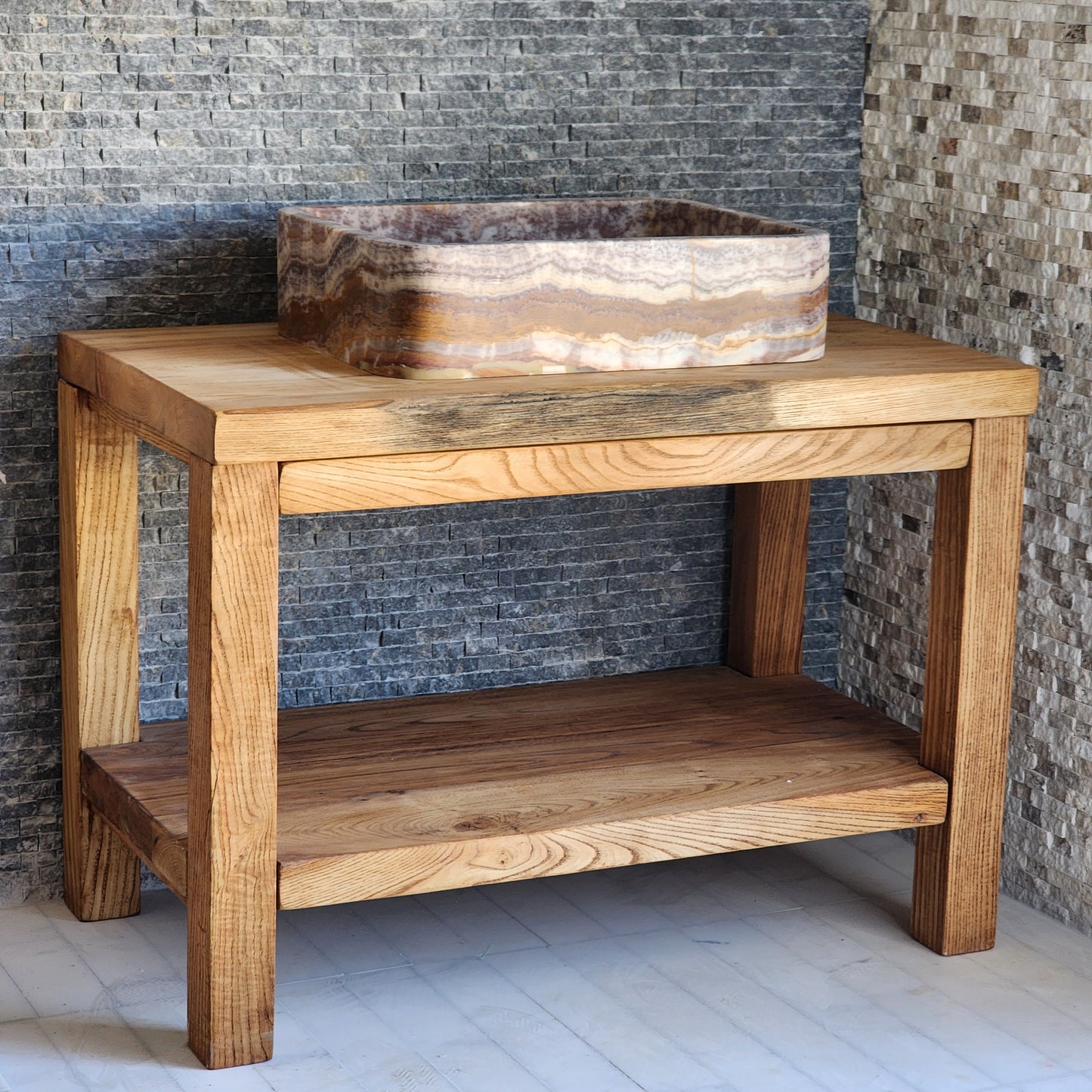 Norhew rectangular onyx vessel sink featuring soft rounded corners and linear pink and cream stone banding.