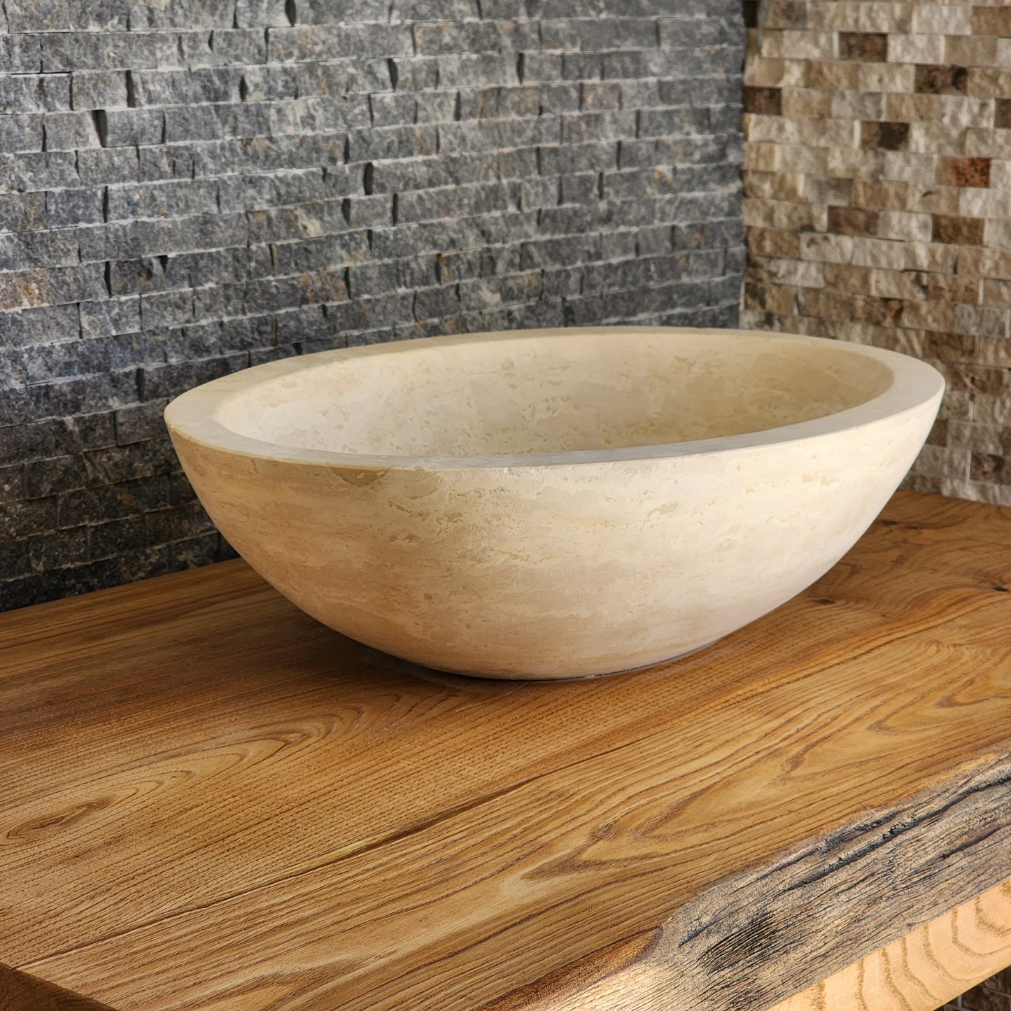 Norhew luxury round solid travertine vessel sink with natural golden-beige pitting and a thick-rimmed profile on a wooden vanity.